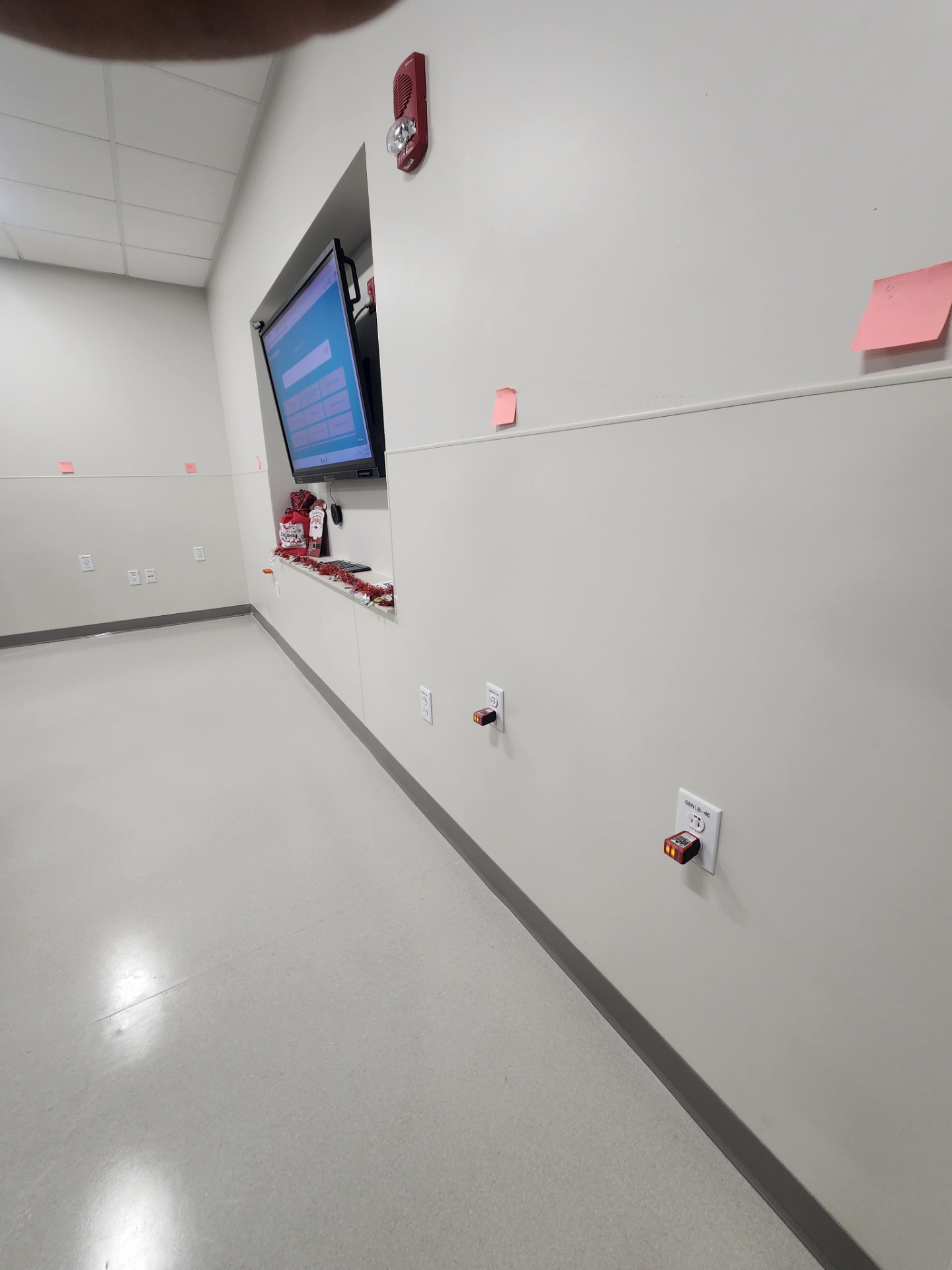 Commercial room with display power, fire alarm device, and receptacles