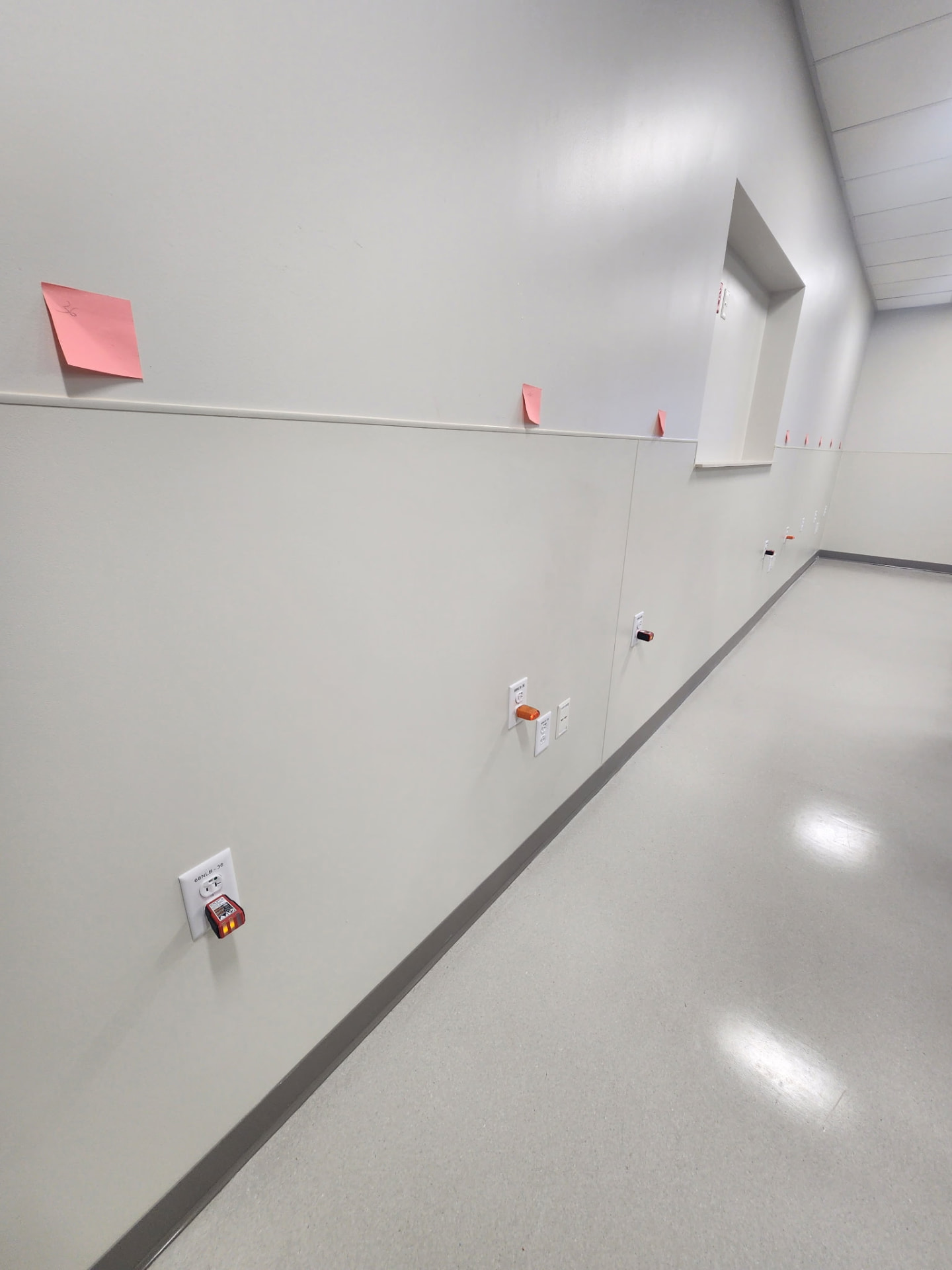 Wall of receptacles with circuit testers confirming correct wiring