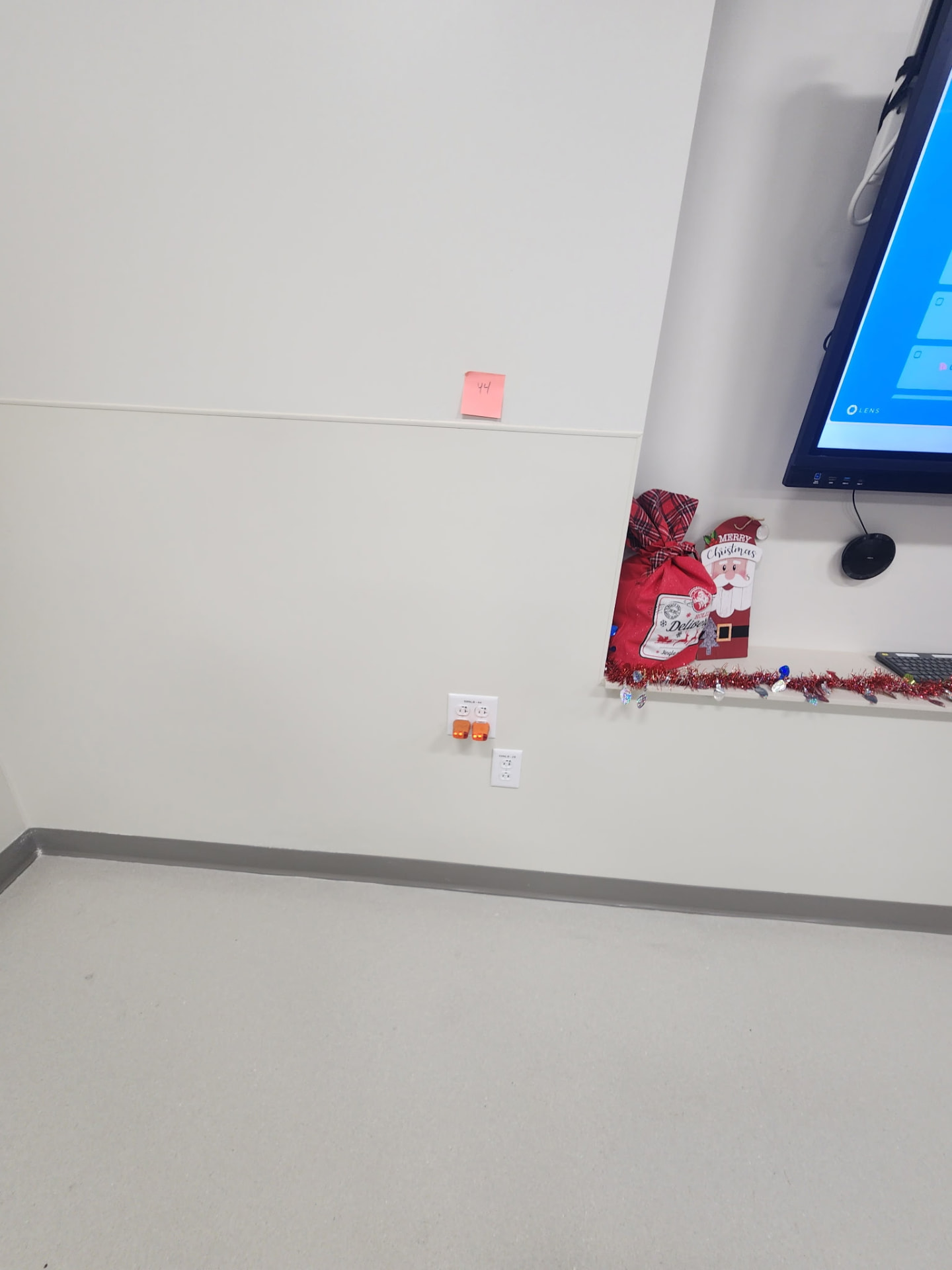 Dedicated quad receptacle installed below a wall-mounted display