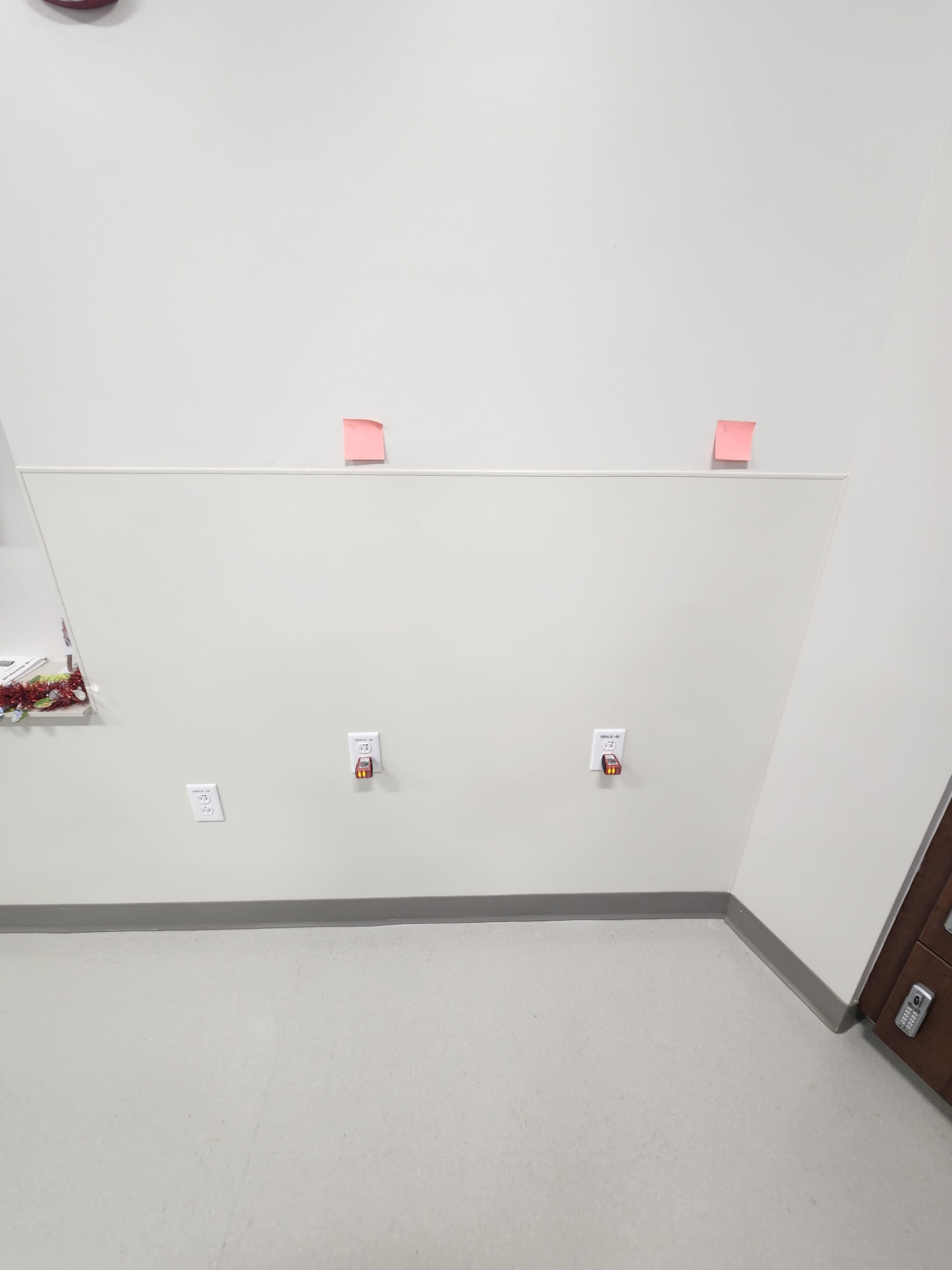 Wall with three commercial receptacles installed and tested