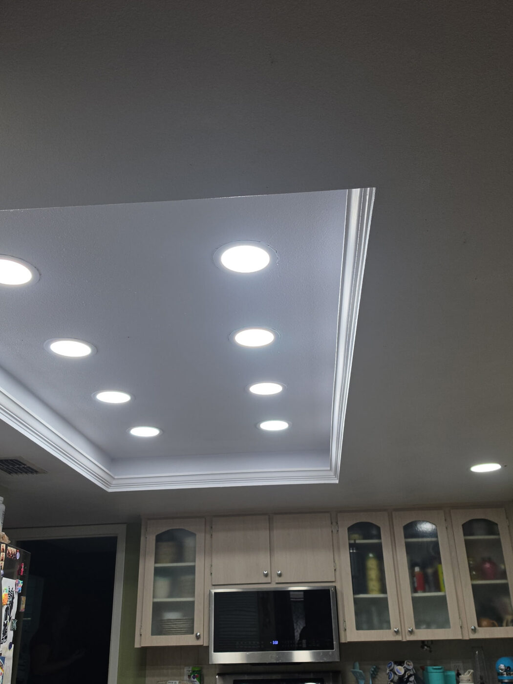Tray ceiling kitchen with eight recessed lights installed